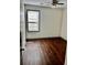 Cozy bedroom showcasing gleaming hardwood floors and a bright window at 2499 Sinclair Trce, Powder Springs, GA 30127