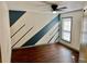 Bright bedroom features wood floors, a modern ceiling fan, and natural light from the large window at 2499 Sinclair Trce, Powder Springs, GA 30127