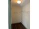 Walk-in closet features built-in shelving and wood floors at 2499 Sinclair Trce, Powder Springs, GA 30127