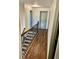 Upstairs hallway with wood floors, doors with blue trim, and natural light at 2499 Sinclair Trce, Powder Springs, GA 30127