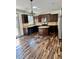 Charming kitchen featuring a functional island, modern appliances, and sleek hardwood flooring at 2499 Sinclair Trce, Powder Springs, GA 30127