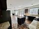 Open-concept kitchen with island, granite countertops, stainless steel appliances, and hardwood floors at 2499 Sinclair Trce, Powder Springs, GA 30127