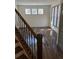 Bright room featuring sleek flooring and large windows, viewed from the staircase at 2499 Sinclair Trce, Powder Springs, GA 30127