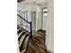 Staircase flowing into a room showcasing sleek flooring, and a white front door at 2499 Sinclair Trce, Powder Springs, GA 30127