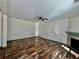 Bright living room features sleek hardwood floors, a ceiling fan, and a cozy fireplace at 2499 Sinclair Trce, Powder Springs, GA 30127
