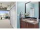 Bright bathroom offering granite vanity, closet, and access to the balcony with city views at 943 Peachtree Ne St # 1910, Atlanta, GA 30309