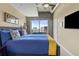 Bright bedroom featuring blue bedding, cityscape view, door to the balcony and contemporary ceiling fan at 943 Peachtree Ne St # 1910, Atlanta, GA 30309