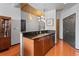 Modern kitchen with granite counters, wood cabinets, stainless steel appliances, and a stylish backsplash at 943 Peachtree Ne St # 1910, Atlanta, GA 30309