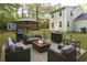 Outdoor patio with seating, fire pit, grill, and adjacent grassy yard at 1276 Seattle Slew Ln, Norcross, GA 30093