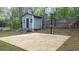 Backyard featuring a shed, basketball court, and green space at 1276 Seattle Slew Ln, Norcross, GA 30093
