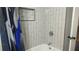 The bathroom showcases a tiled shower with a shower curtain and recessed storage at 1276 Seattle Slew Ln, Norcross, GA 30093
