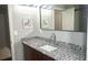 Granite counters and modern fixtures accent this well-lit bathroom with a large mirror at 1276 Seattle Slew Ln, Norcross, GA 30093