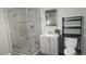 Modern bathroom featuring an enclosed glass shower, vanity, and a toilet with shelving at 1276 Seattle Slew Ln, Norcross, GA 30093