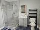 Modern bathroom featuring an enclosed glass shower, vanity, and a toilet with shelving at 1276 Seattle Slew Ln, Norcross, GA 30093