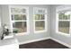Bright bathroom with a large window, gray walls, wood-look floors, and a white sink at 1276 Seattle Slew Ln, Norcross, GA 30093