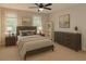 Cozy bedroom featuring a ceiling fan, natural light, and neutral decor at 1276 Seattle Slew Ln, Norcross, GA 30093
