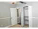This bedroom features a closet with open doors, neutral carpeting and a ceiling fan at 1276 Seattle Slew Ln, Norcross, GA 30093