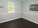 Bedroom with hard wood floors and a large window at 1276 Seattle Slew Ln, Norcross, GA 30093