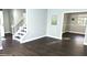 Open entryway featuring hardwood floors, a staircase, and access to other rooms at 1276 Seattle Slew Ln, Norcross, GA 30093