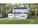 Charming two-story home with light green siding, a well-manicured lawn, and attached garage for modern living at 1276 Seattle Slew Ln, Norcross, GA 30093