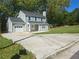 Charming two-story home with light green siding, a well-manicured lawn, and attached garage for modern living at 1276 Seattle Slew Ln, Norcross, GA 30093