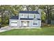 Charming two-story home with light green siding, a well-manicured lawn, and attached garage for modern living at 1276 Seattle Slew Ln, Norcross, GA 30093