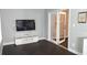 Neutral living area features hard-surface floors, a TV and console, and a doorway to another room at 1276 Seattle Slew Ln, Norcross, GA 30093