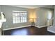 Clean, neutral living room with dark flooring and a window at 1276 Seattle Slew Ln, Norcross, GA 30093