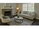 Inviting living room with a cozy fireplace, plush sofa, and plenty of natural light at 1276 Seattle Slew Ln, Norcross, GA 30093