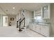 Finished basement features a wet bar with granite countertops, storage cabinets, and carpeted floors at 1418 Waterford Green Dr, Marietta, GA 30068