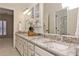 Bright bathroom features a granite countertop, double sink, large mirror, and ample cabinet space at 1418 Waterford Green Dr, Marietta, GA 30068