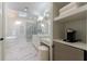 Bathroom with a marble shower, soaking tub, mini-fridge, and vanity with great natural light and elegant finishes at 1418 Waterford Green Dr, Marietta, GA 30068