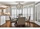 Sunlit dining area features hardwood floors and stylish chandelier. Shutters adorn windows at 1418 Waterford Green Dr, Marietta, GA 30068