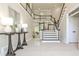Elegant foyer featuring a grand staircase, tile flooring, and stylish decor at 1418 Waterford Green Dr, Marietta, GA 30068