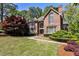 Charming brick home with manicured lawn, mature trees, and beautiful landscaping at 1418 Waterford Green Dr, Marietta, GA 30068