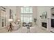 Grand living room featuring high ceilings, built-ins, fireplace, and plantation shutters at 1418 Waterford Green Dr, Marietta, GA 30068