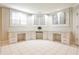Spacious home office/study with white cabinets, built-in desks, tile floors and plantation shutters at 1418 Waterford Green Dr, Marietta, GA 30068