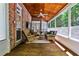 Cozy sunroom with wood floors, exposed brick, ceiling fan and comfortable seating with a view at 1418 Waterford Green Dr, Marietta, GA 30068