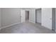 Bright bedroom with soft gray walls, plush carpet, and an entrance to a walk-in closet at 2075 Ivy Ln, Union City, GA 30291