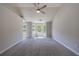 Large bedroom featuring a ceiling fan, neutral walls, plush carpet, and bright windows at 2075 Ivy Ln, Union City, GA 30291
