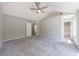 Airy bedroom with gray walls, plush carpet, and open view to a bathroom and closet at 2075 Ivy Ln, Union City, GA 30291