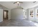 Bright bedroom featuring a ceiling fan, neutral walls, plush carpet, and bright windows at 2075 Ivy Ln, Union City, GA 30291