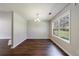 Dining area with hardwood floors, a chandelier, and a large window offering a view of the backyard at 2075 Ivy Ln, Union City, GA 30291