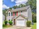 Charming two-story home featuring a single-car garage, red shutters, and well-maintained landscaping in a suburban setting at 2075 Ivy Ln, Union City, GA 30291