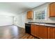 Kitchen featuring black appliances and wooden cabinets with an attached dining room at 2075 Ivy Ln, Union City, GA 30291