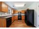 Kitchen featuring black appliances and wooden cabinets at 2075 Ivy Ln, Union City, GA 30291