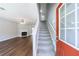 Bright living room showcasing a fireplace, ceiling fan, hardwood floors, a staircase, and a modern interior design at 2075 Ivy Ln, Union City, GA 30291