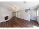 Open concept living room with hardwood floors, fireplace, staircase, and natural light at 2075 Ivy Ln, Union City, GA 30291