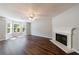 Bright living room featuring hardwood floors, a fireplace, large windows, and neutral wall colors at 2075 Ivy Ln, Union City, GA 30291