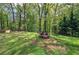 Enjoy the backyard featuring a fire pit area, wooden swing and plenty of shade at 5534 Blackhawk Dr, Acworth, GA 30102